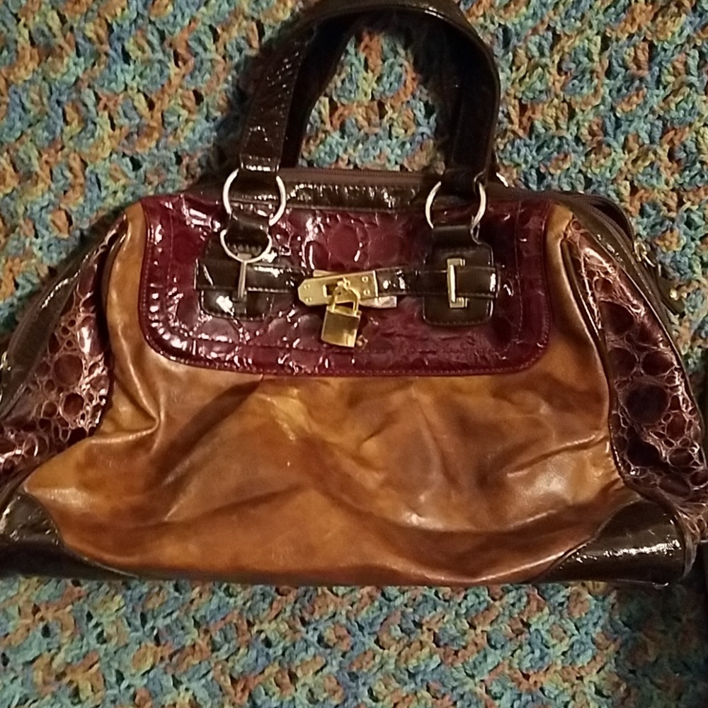 Brown bag with faux crocodile trim. Patent details